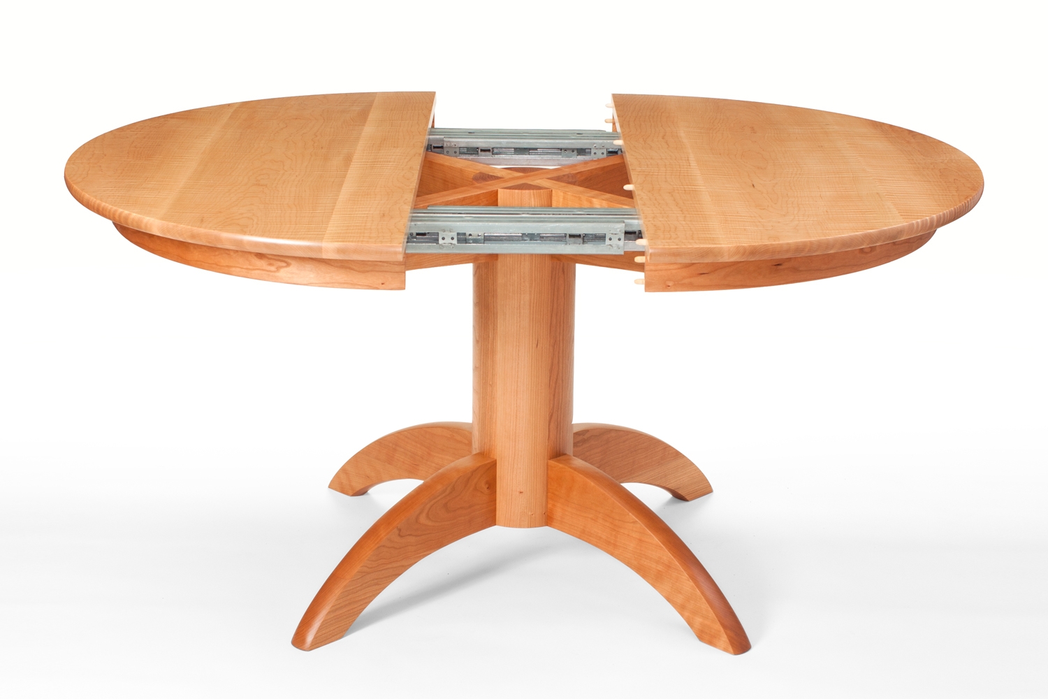 Our Mendelsohn Pedestal Table in cherry open to receive a leaf.