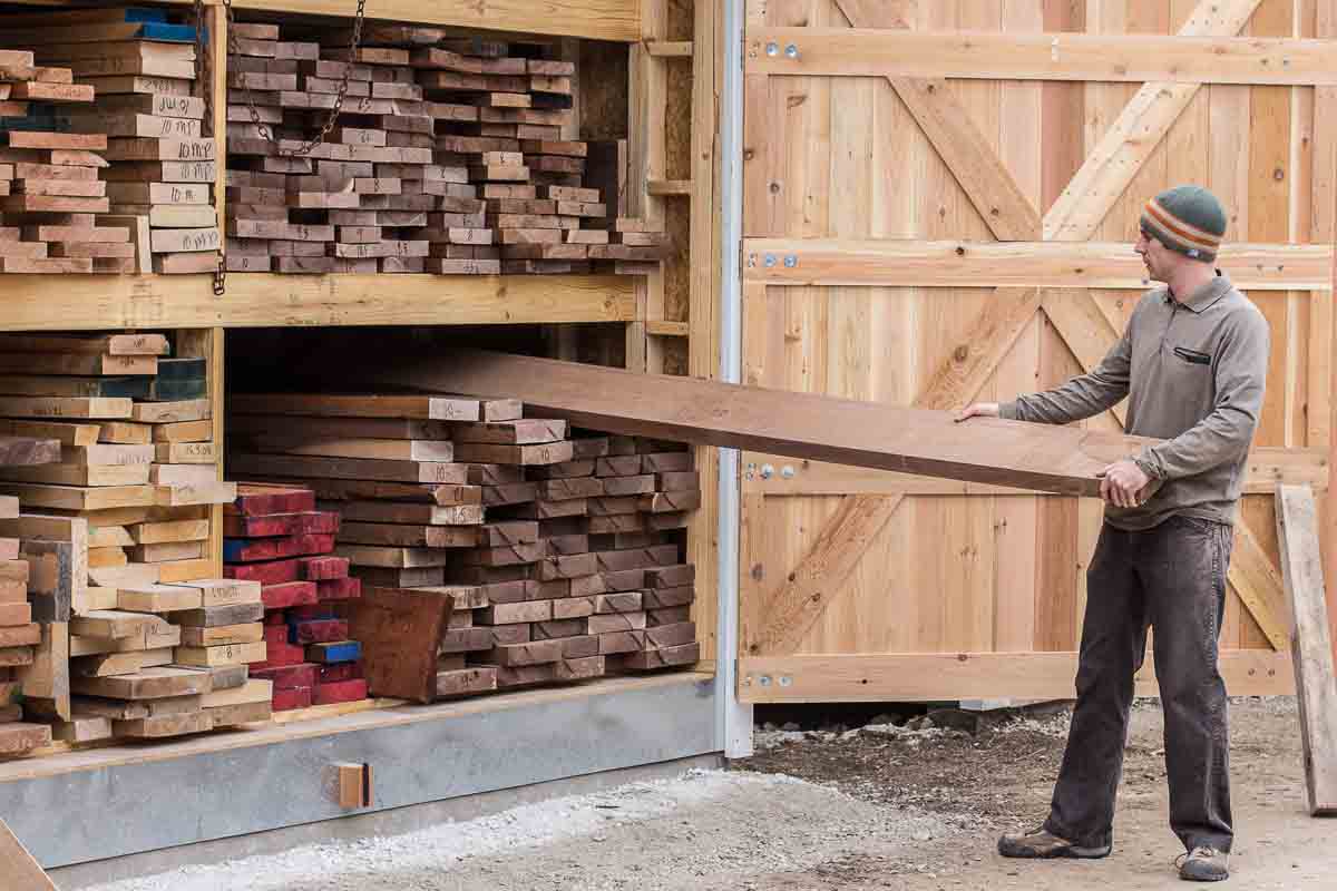 Austin pulling lumber from the shed