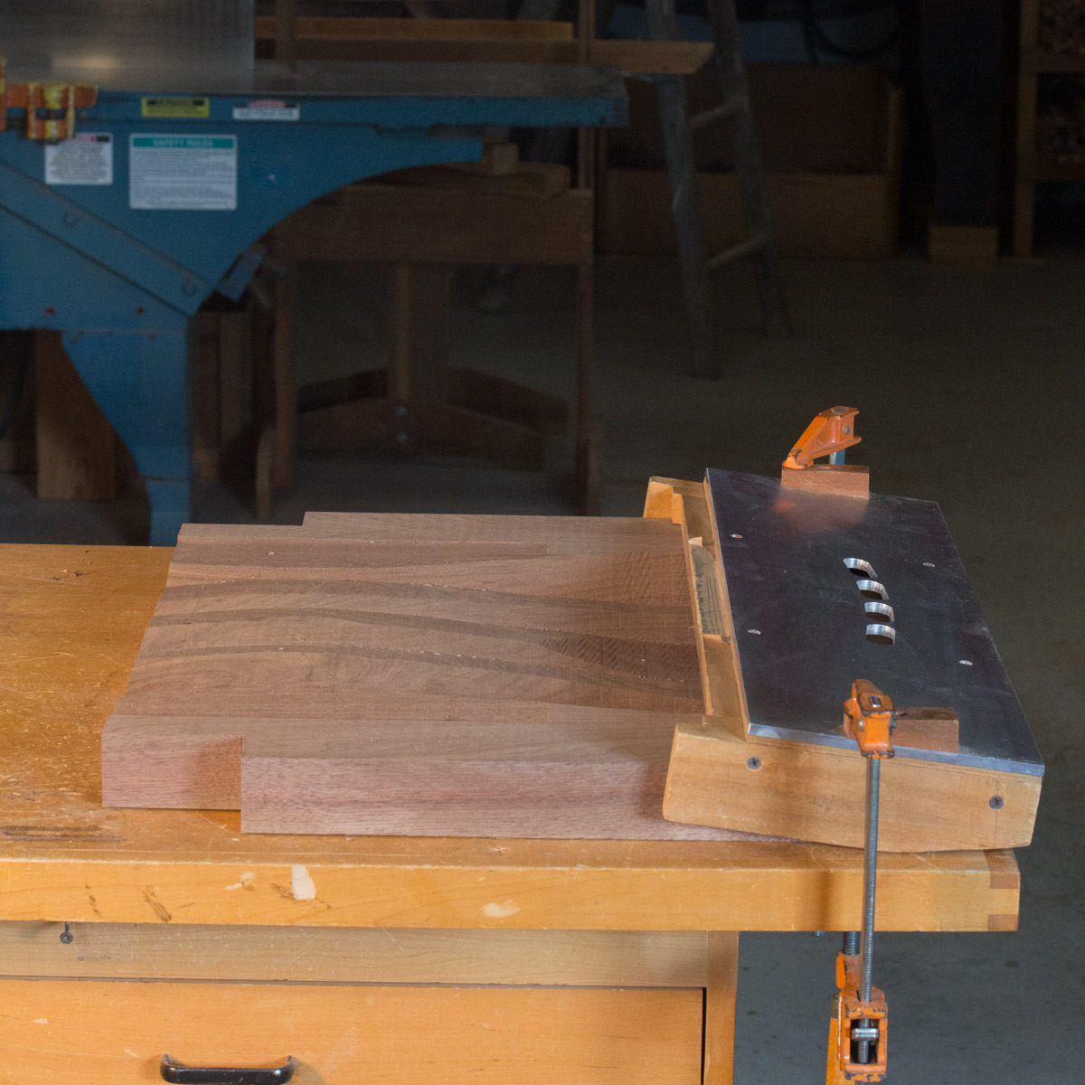 walnut rocking chair seat with splat mortising fixture clamped in place