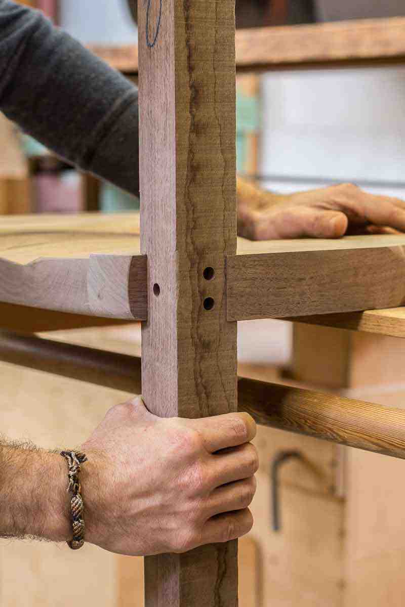 close up of fitting front leg to seat