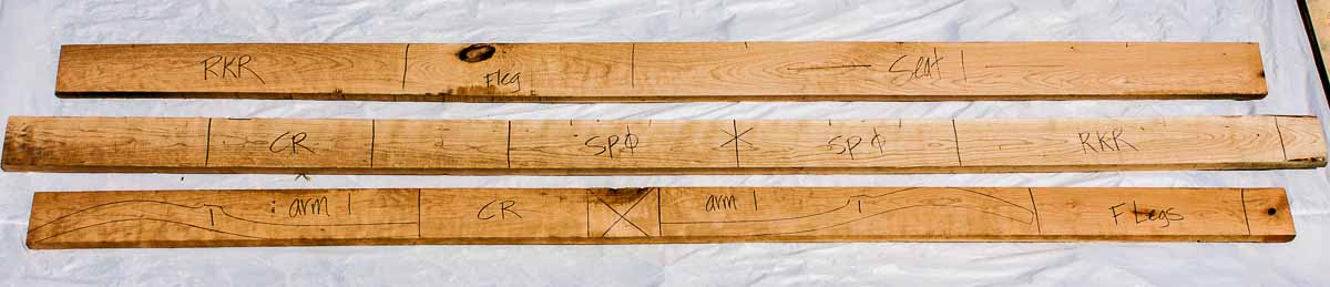 rocking chair parts laid out on cherry lumber