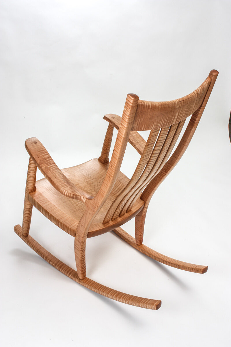 A Custom Special Edition Weeks Rocker® in highly figured wood. The view is angled from above to show curves and beautiful wood.