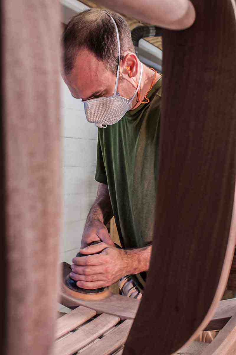 Austin sanding a rocking chair with air sander