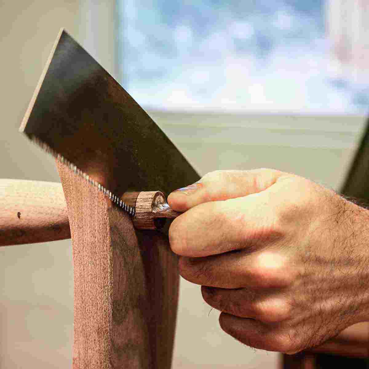 sawing front leg tenon flush with arm, closeup