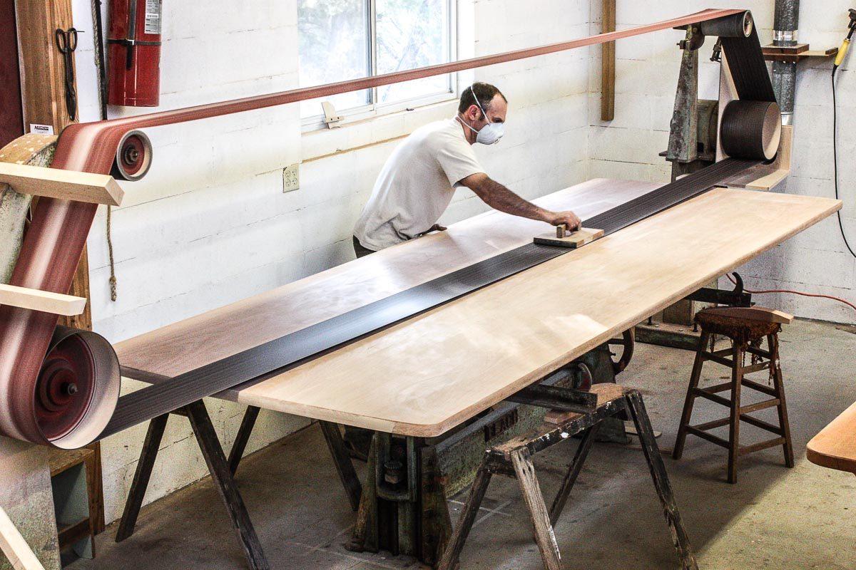 Austin stroke sanding a trestle table top