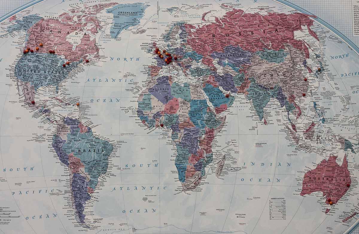 map of the world with pins to locate patrons