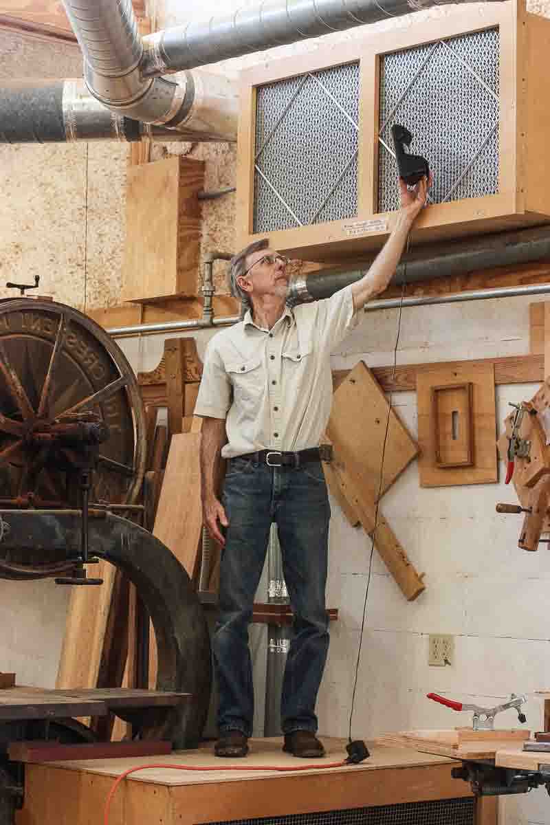 Gary measuring dust particles at the return air plenum