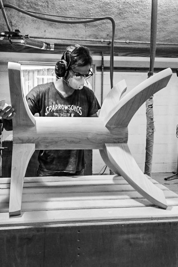 John Michael sanding a base