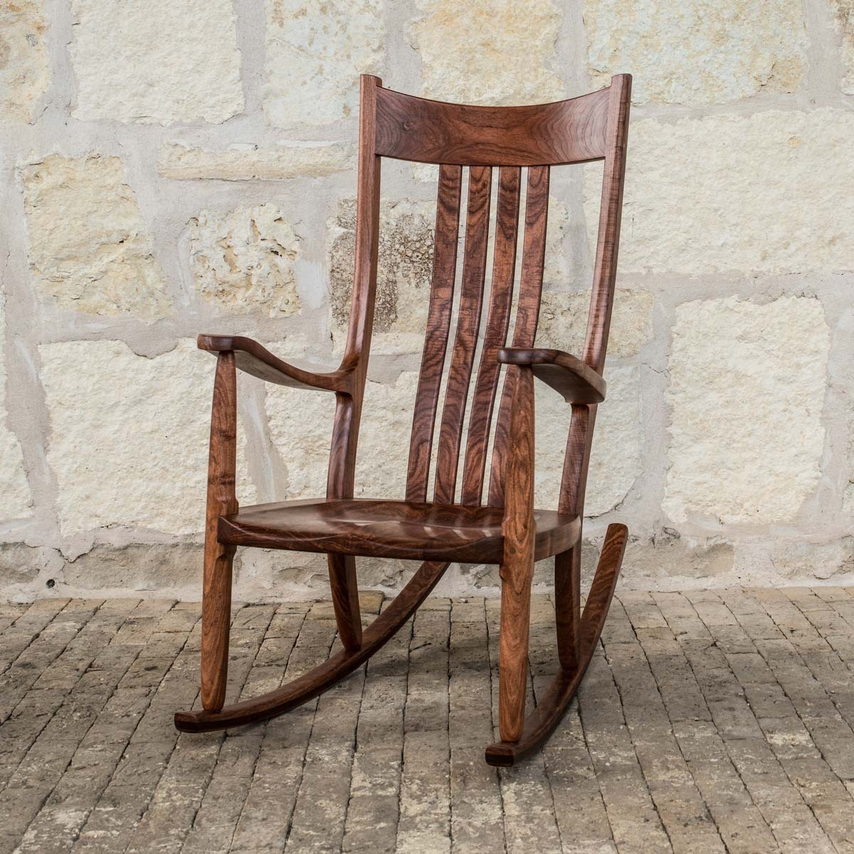 a comfortable rocking chair on bricks