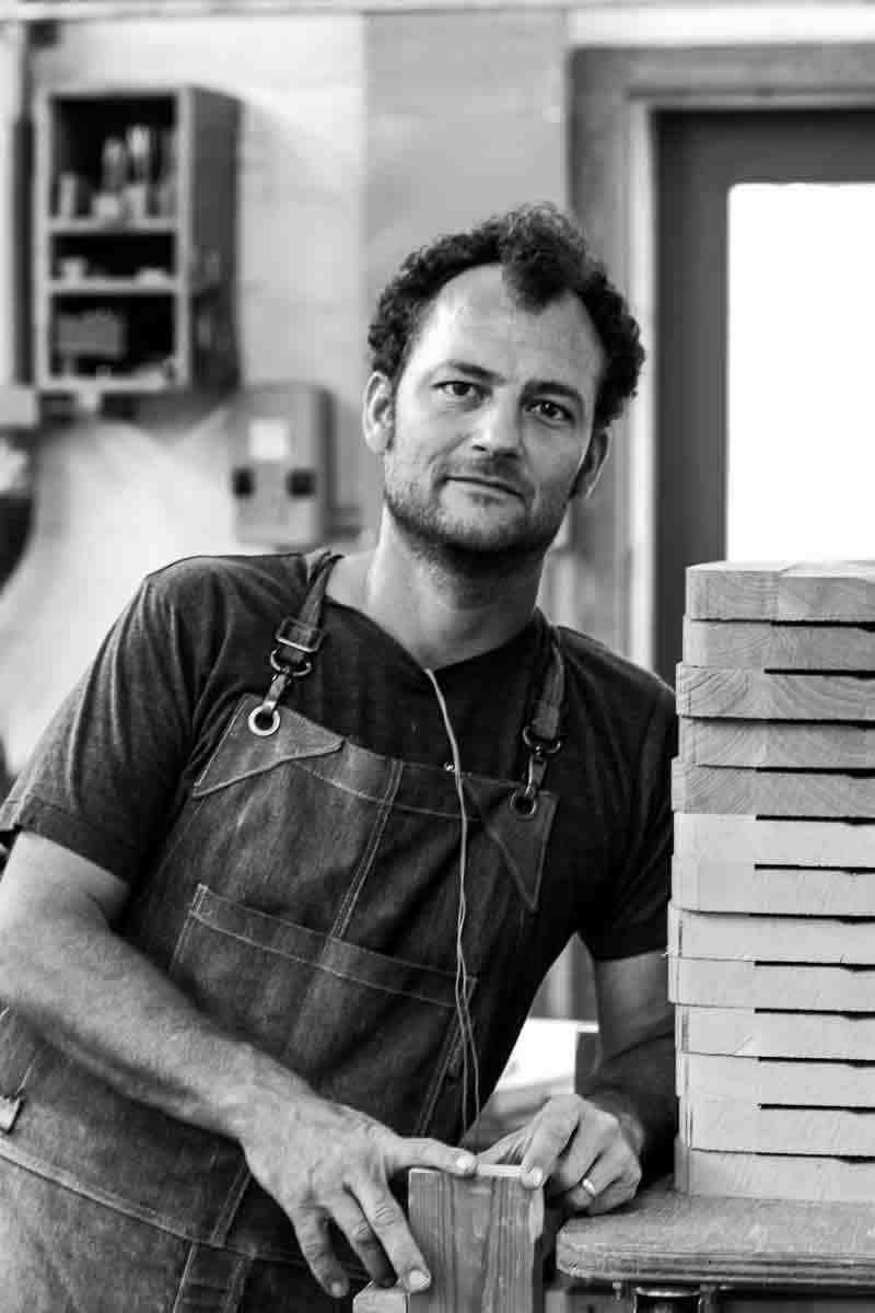 Will with a stack of dining chair seats