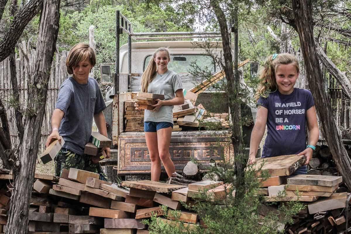 Asa, Bela, and Wiley stacking stove wood