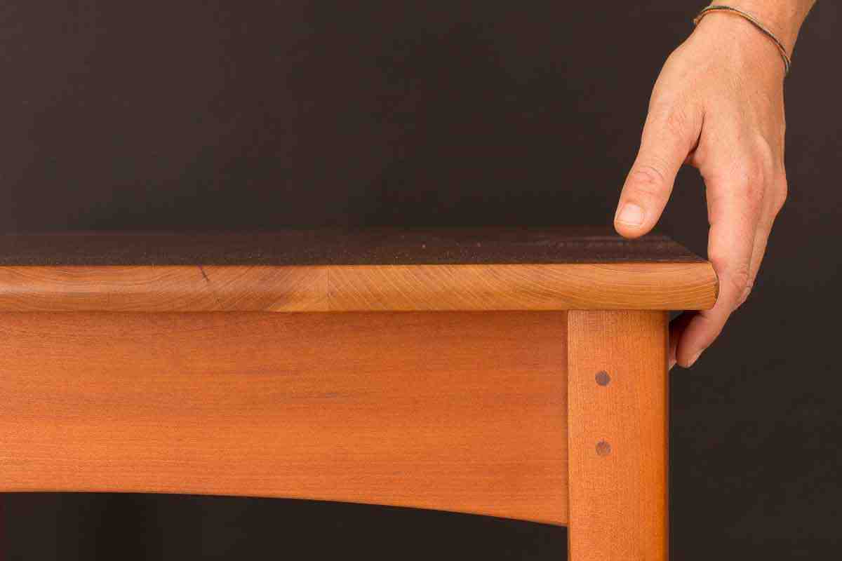 hand on table top edge, 3