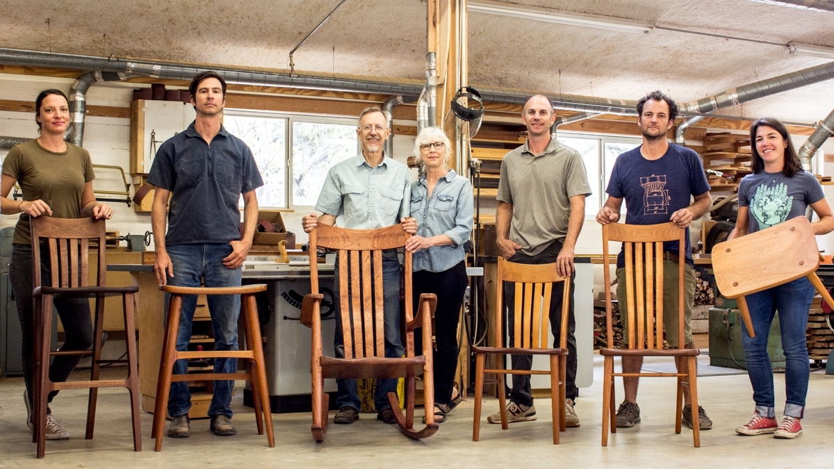 the company standing behind the furniture
