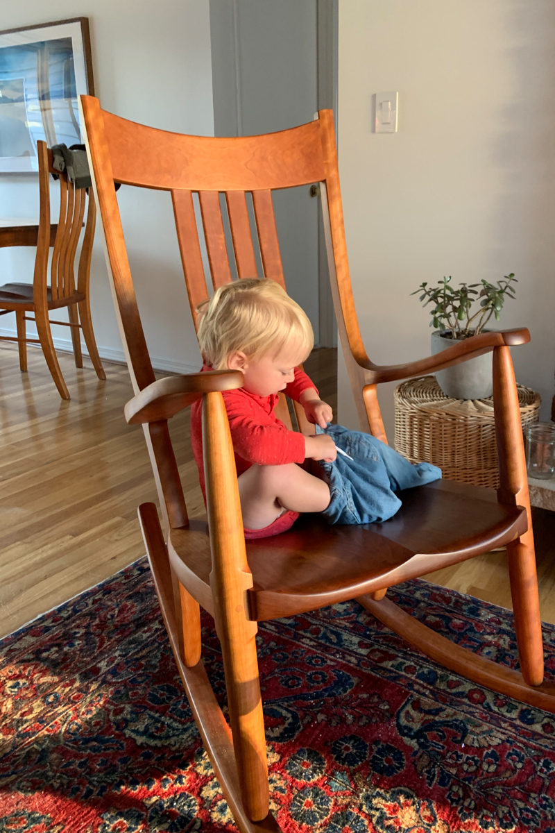 Toddler in a cherry rocking chair, a rocker is for everyone