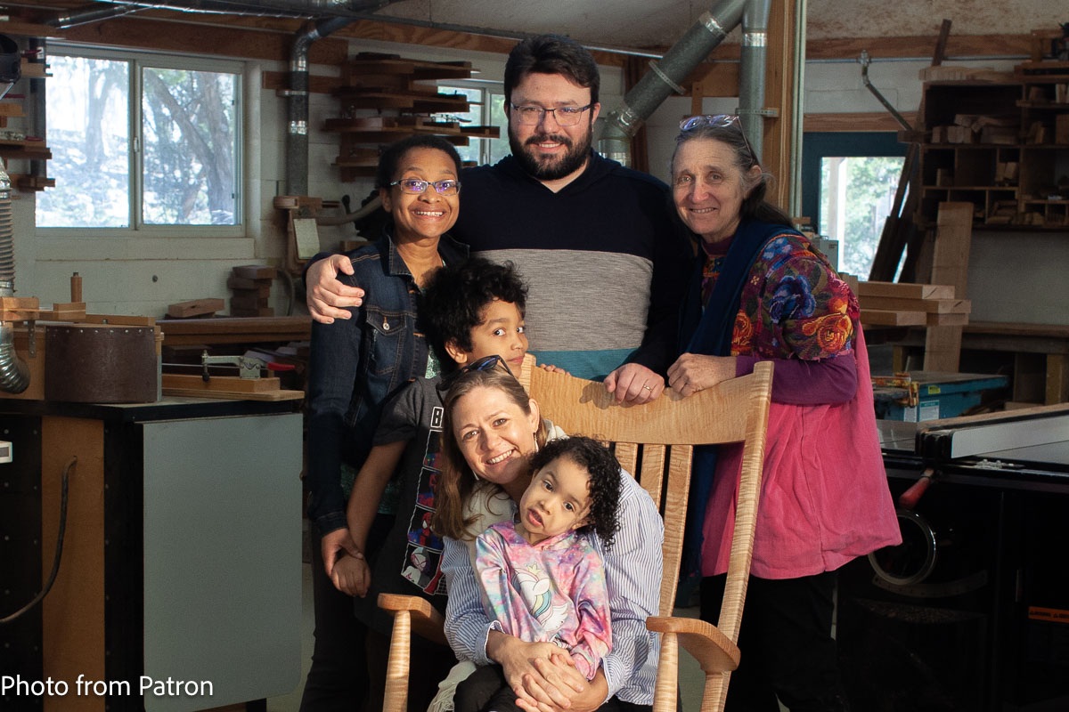 Family in rocking chair in our shop