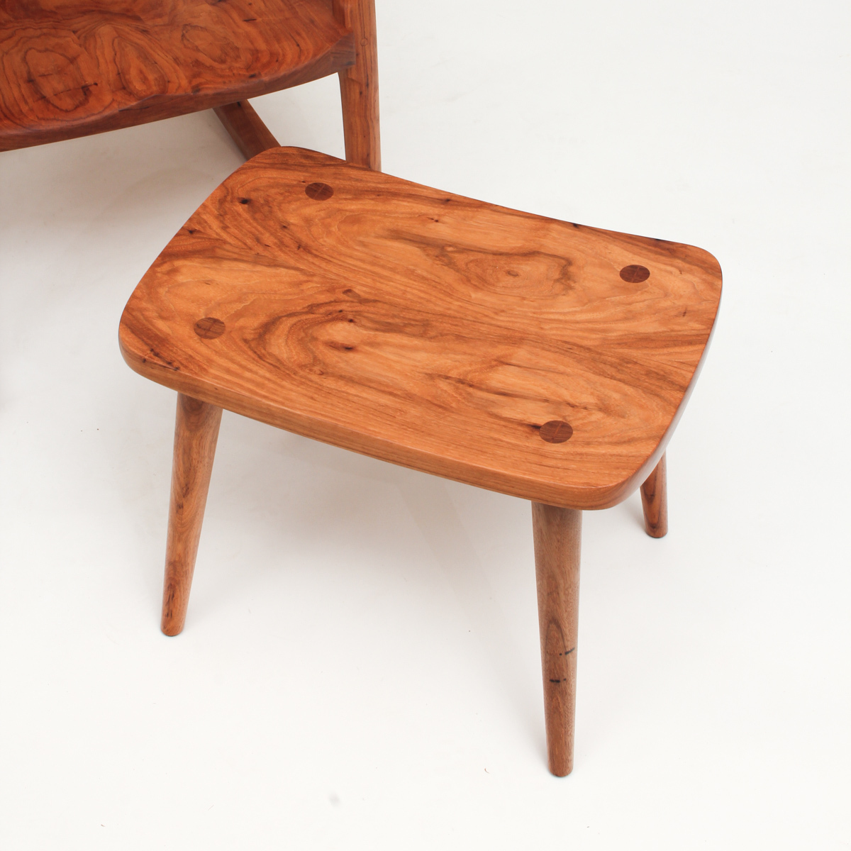 View of the grain on a Harris Footstool, part of a matching set.