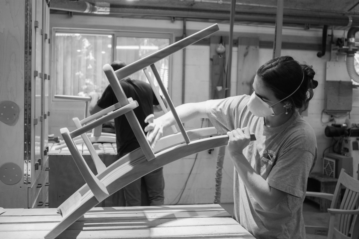 Rachel sanding a dining chair