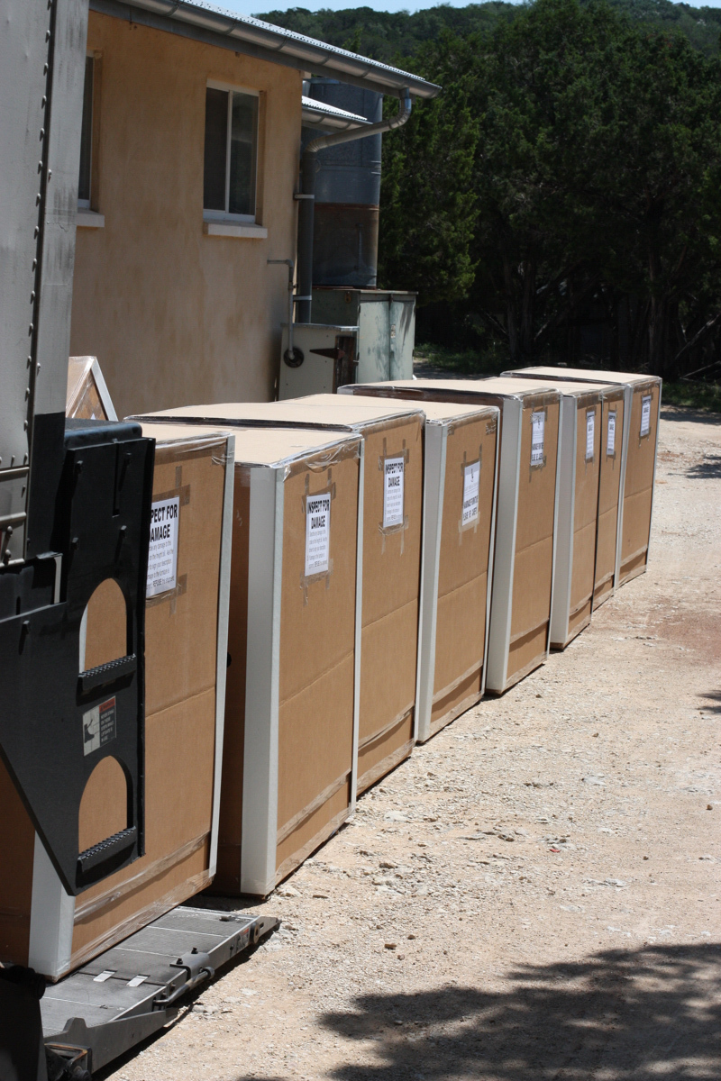Eight crated rocking chairs loading on truck