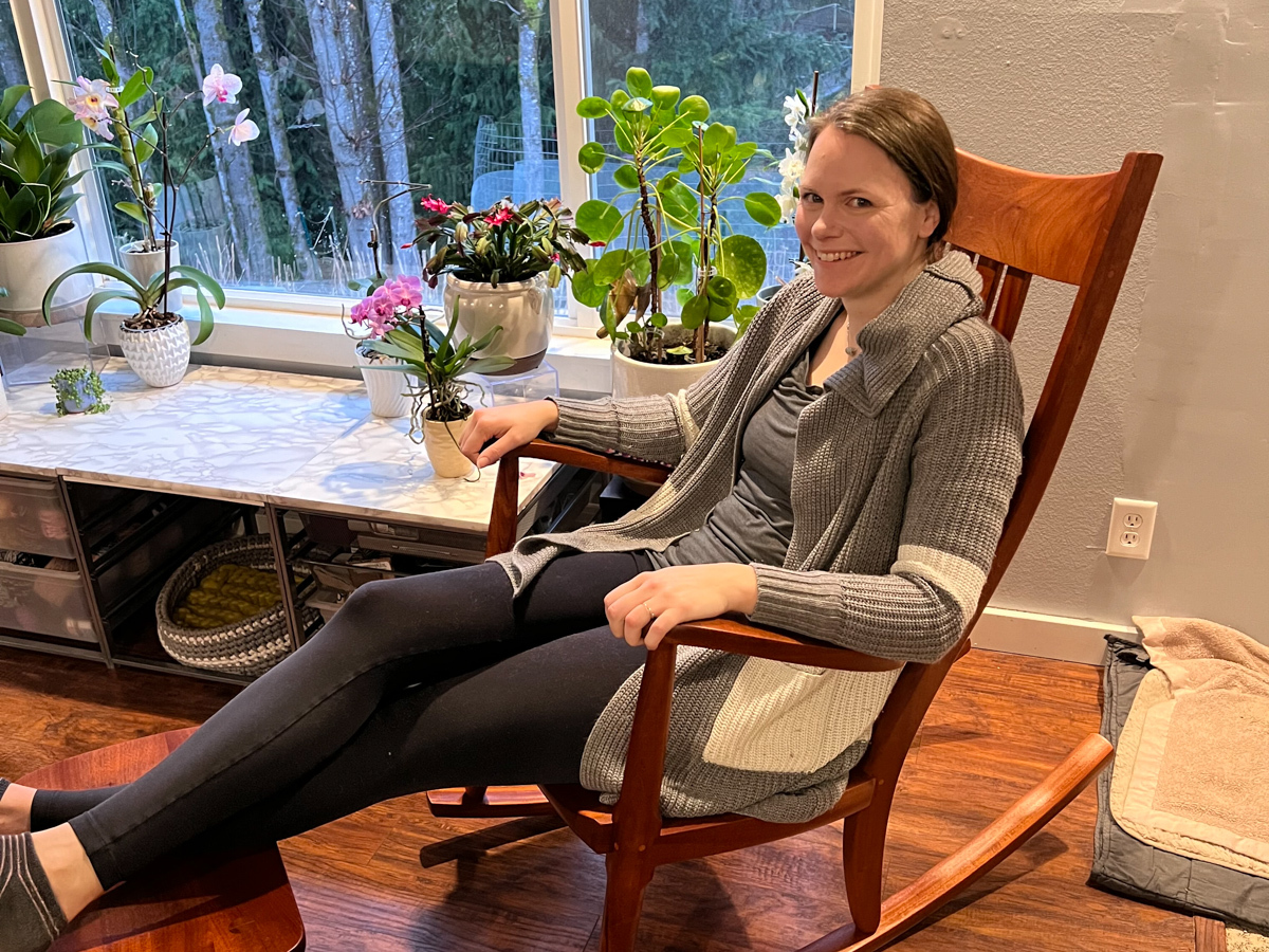 a woman in a Weeks Rocking Chair sitting in comfort and smiling.
