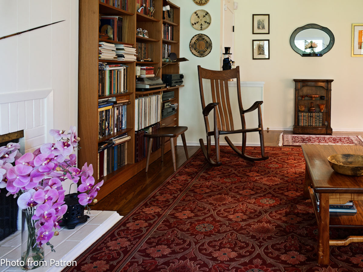 Walnut Rocking Chair in LR with purple flowers in vase