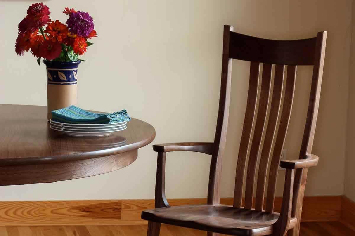 arm chair, dining table, and flowers in vase