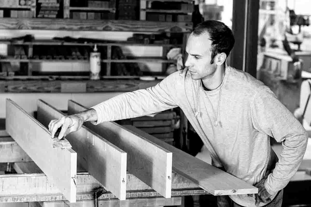 Austin spreading glue on table top boards