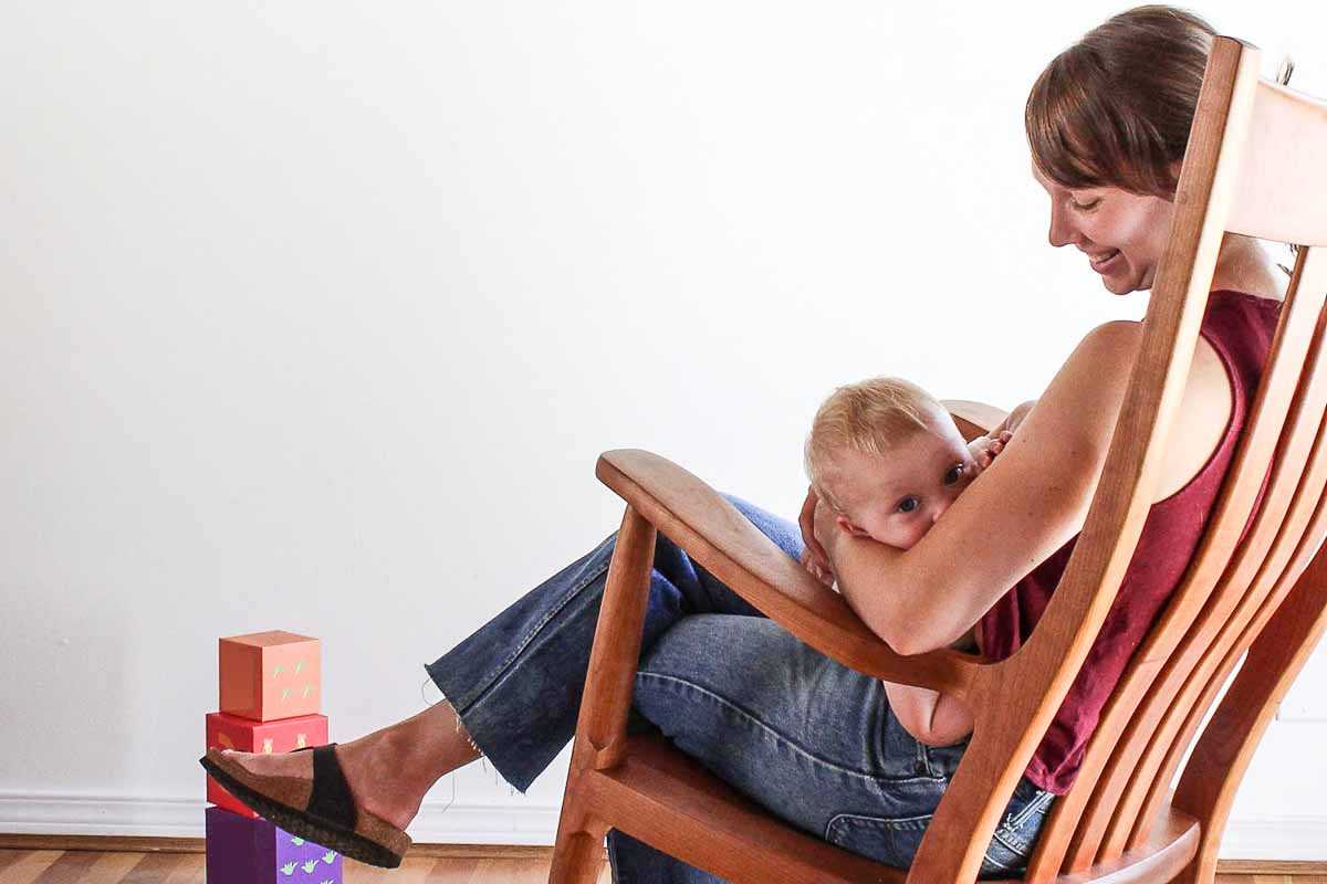 mother and child in rocker in nursery