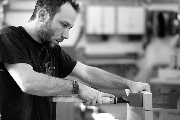 Aaron sawing through tenons flush