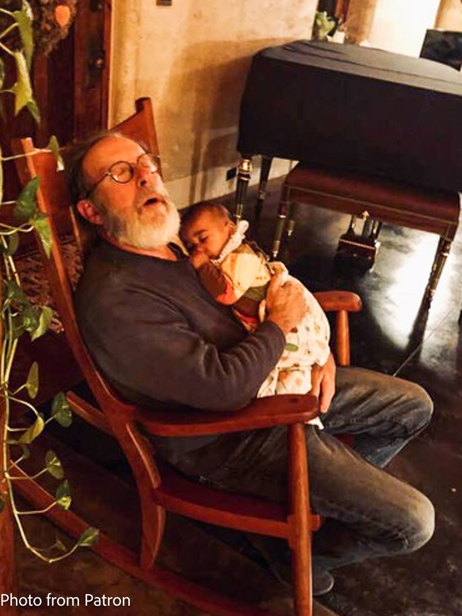 grandfather and grand baby sleeping in rocker