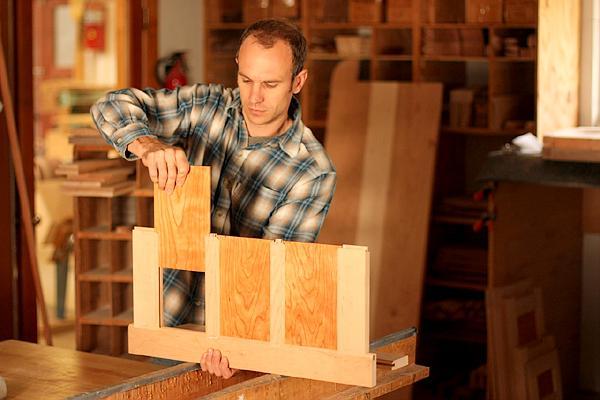 Austin assembling a desk panel