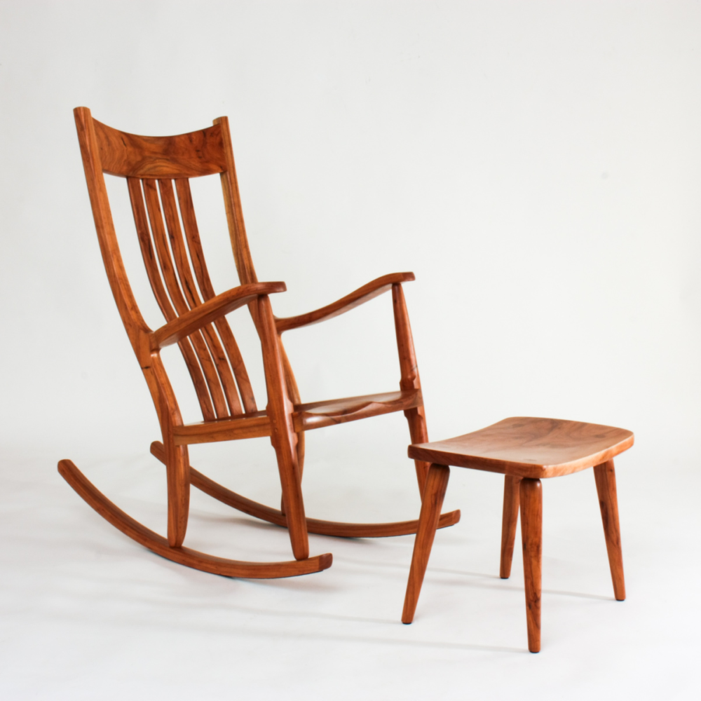 one of a kind pecan rocker and a footstool in our studio on a white background.